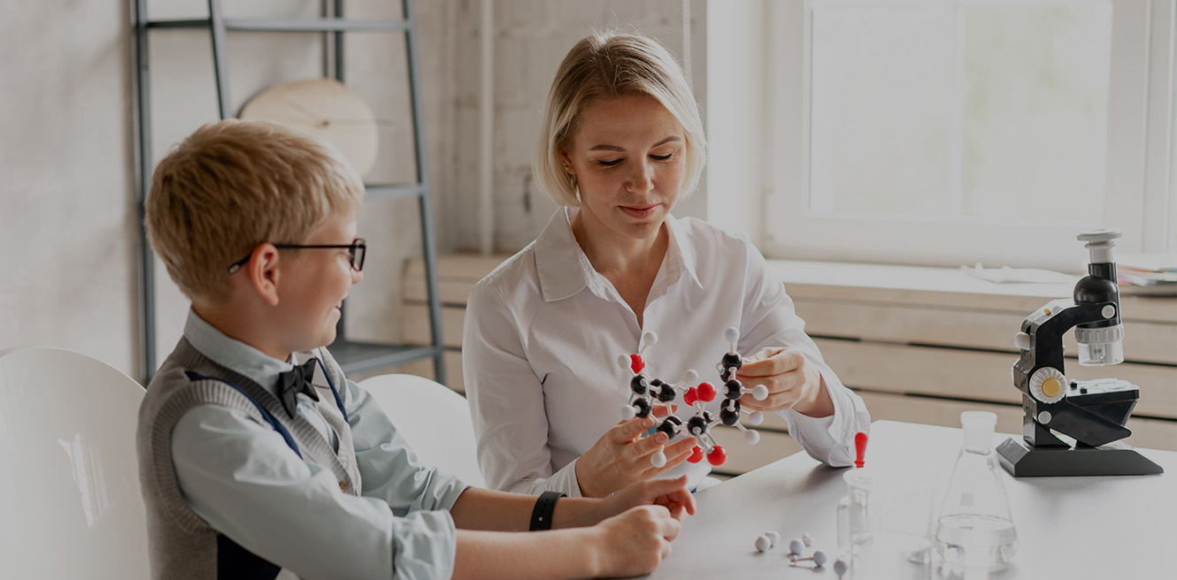 Female science tutor in Akron studying chemistry with student